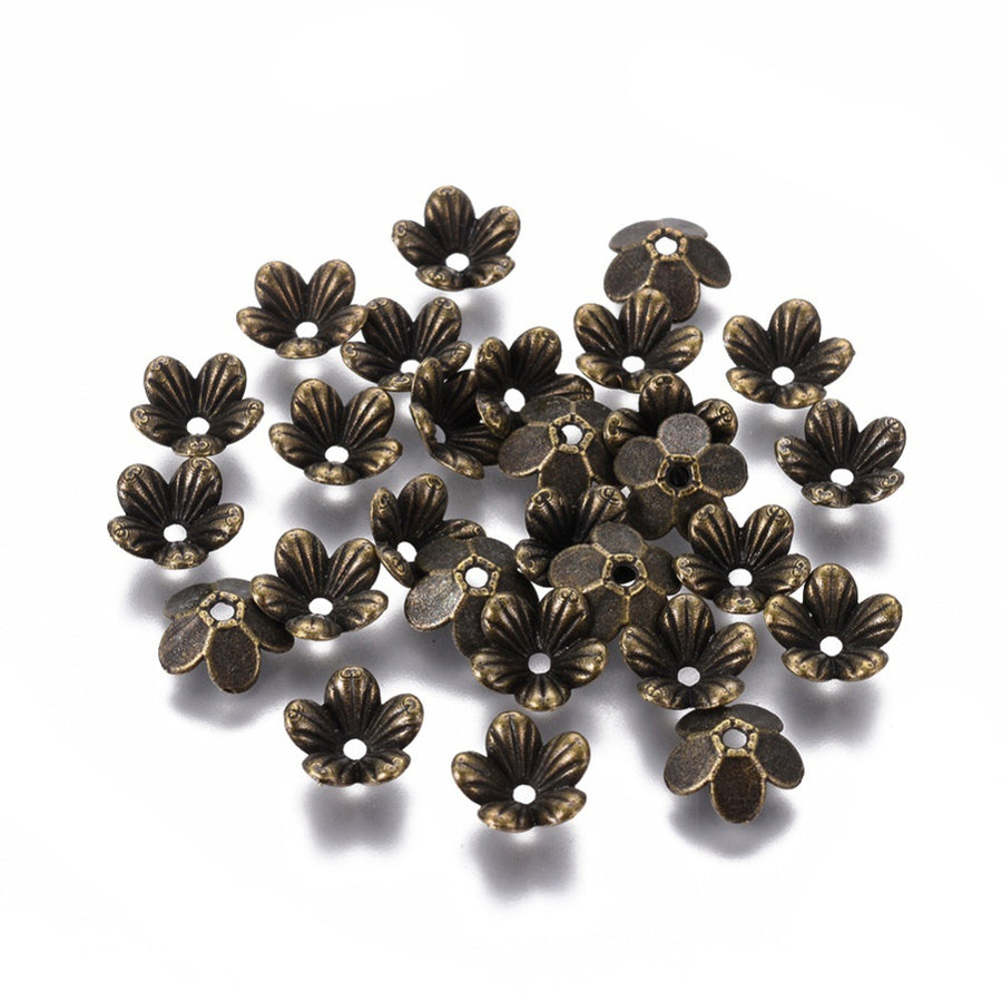 Antique Bronze 5-Petal Flower Spacer Beads. Flower Shaped Bead Caps, Bronze Color Bead Cones. Flower Spacers for DIY Jewelry Making Projects.   Size: 9mm Diameter, 3mm Length, Hole: 1.5mm, approx. 50pcs/package.  Material: Alloy Flower Bead Caps. Antique Bronze Color. Lead, Cadmium and Nickel Free.