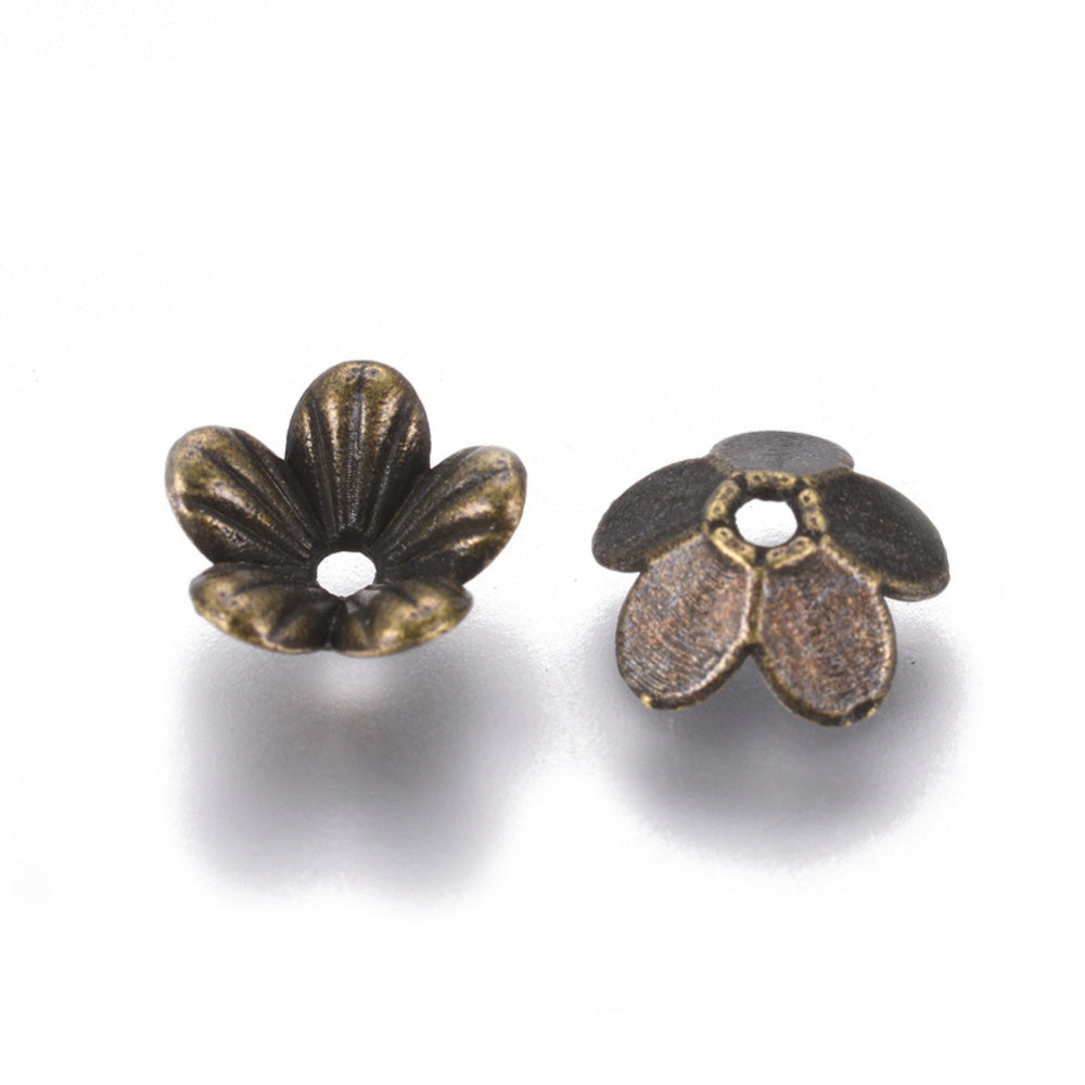 Antique Bronze 5-Petal Flower Spacer Beads. Flower Shaped Bead Caps, Bronze Color Bead Cones. Flower Spacers for DIY Jewelry Making Projects.   Size: 9mm Diameter, 3mm Length, Hole: 1.5mm, approx. 50pcs/package.  Material: Alloy Flower Bead Caps. Antique Bronze Color. Lead, Cadmium and Nickel Free.