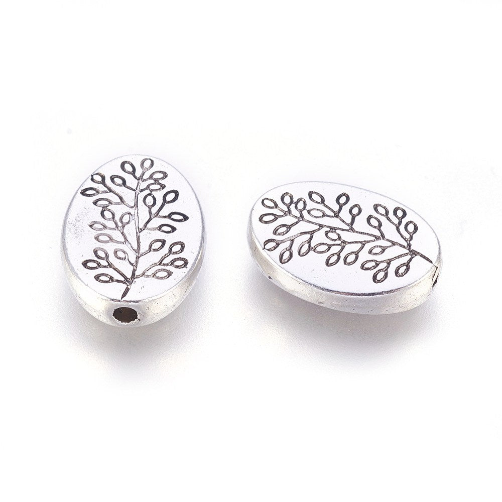 Tibetan Oval Spacer Beads, Antique Silver Color. Oval Spacers for DIY Jewelry Making Projects. High Quality, Classy, Non-Tarnish Spacers for Beading Projects. Antique Silver Tibetan Style Alloy Spacer Beads. Oval Shape with Leaf Design. Shinny Finish. 100% Lead and Nickel Free Spacers. www.beadlot.com