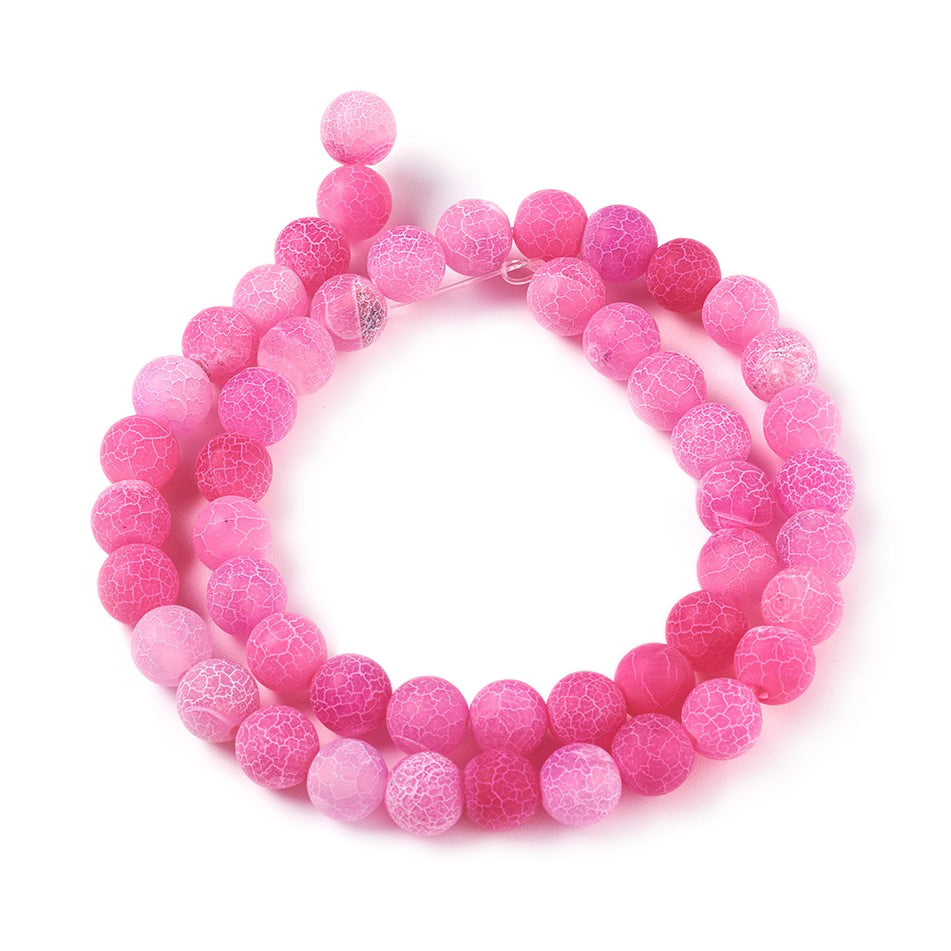 Crackle Agate Beads, Dyed, Round, Pink Color. Matte Semi-Precious Gemstone Beads for Jewelry Making. Great for Stretch Bracelets and Necklaces.  Size: 8mm Diameter, Hole: 1mm; approx. 46pcs/strand, 14.5" Inches Long.  Material: Natural & Dyed Crackle Agate, Frosted Pink Color with White Crackle Pattern. The Crackle Appearance is Created by Heating the Stone to Extreme Temperatures. Unpolished, Matte Finish.