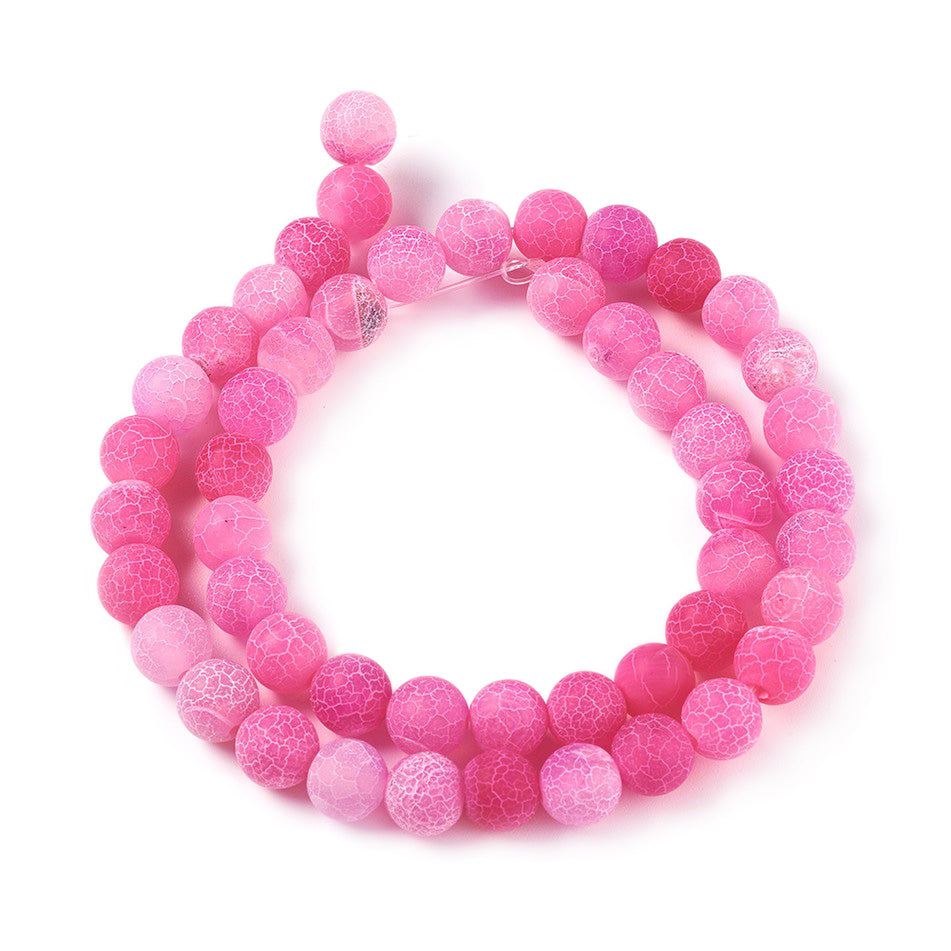 Crackle Agate Beads, Dyed, Round, Pink Color. Matte Semi-Precious Gemstone Beads for Jewelry Making. Great for Stretch Bracelets and Necklaces.  Size: 8mm Diameter, Hole: 1mm; approx. 46pcs/strand, 14.5" Inches Long.  Material: Natural & Dyed Crackle Agate, Frosted Pink Color with White Crackle Pattern. The Crackle Appearance is Created by Heating the Stone to Extreme Temperatures. Unpolished, Matte Finish.