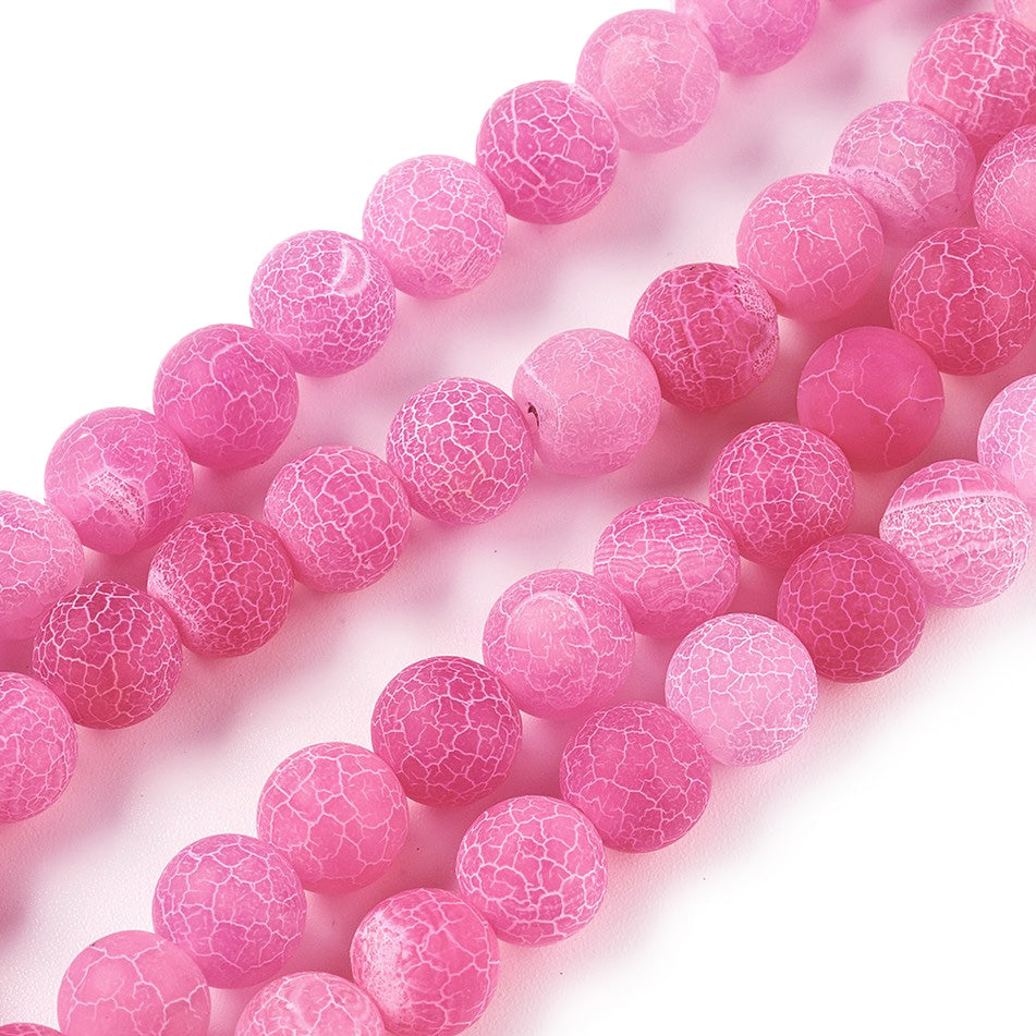 Crackle Agate Beads, Dyed, Round, Pink Color. Matte Semi-Precious Gemstone Beads for Jewelry Making. Great for Stretch Bracelets and Necklaces.  Size: 8mm Diameter, Hole: 1mm; approx. 46pcs/strand, 14.5" Inches Long.  Material: Natural & Dyed Crackle Agate, Frosted Pink Color with White Crackle Pattern. The Crackle Appearance is Created by Heating the Stone to Extreme Temperatures. Unpolished, Matte Finish.