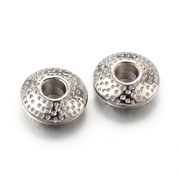 Tibetan Flat Round Spacer Beads, Platinum Silver Color. Silver Spacers for DIY Jewelry Making Projects. Disc Space Beads with Dot Design.   Size: 8mm Wide, 3mm Thick, Hole: 2.5mm, approx. 25pcs/bag.   Material:  Tibetan Style, Shinny Finish. Platinum Silver Color. Cadmium, Lead and Nickel Free Spacers.