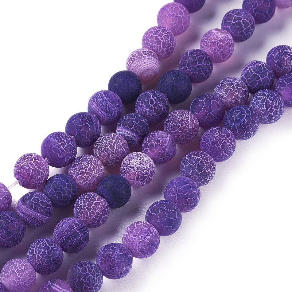 Crackle Agate Beads, Dyed, Round, Purple Color. Matte Semi-Precious Gemstone Beads for Jewelry Making. Great for Stretch Bracelets and Necklaces.  Size: 8mm Diameter, Hole: 1mm; approx. 46pcs/strand, 14.5" Inches Long.  Material: Natural & Dyed Crackle Agate, Frosted Purple Color with White Crackle Pattern. The Crackle Appearance is Created by Heating the Stone to Extreme Temperatures. Unpolished, Matte Finish.