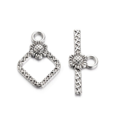 Rhombus with Flower Design Toggle Clasps for DIY Jewelry Making.  Size: 21mm Length, 15mm Width; Bar: 24x10mm, Hole: 2mm, 5 set/package.  Material: Antique Silver Color Alloy Toggle Clasps, Cadmium and Lead Free.   Usage: These Clasp are used to finish off necklaces or bracelets.