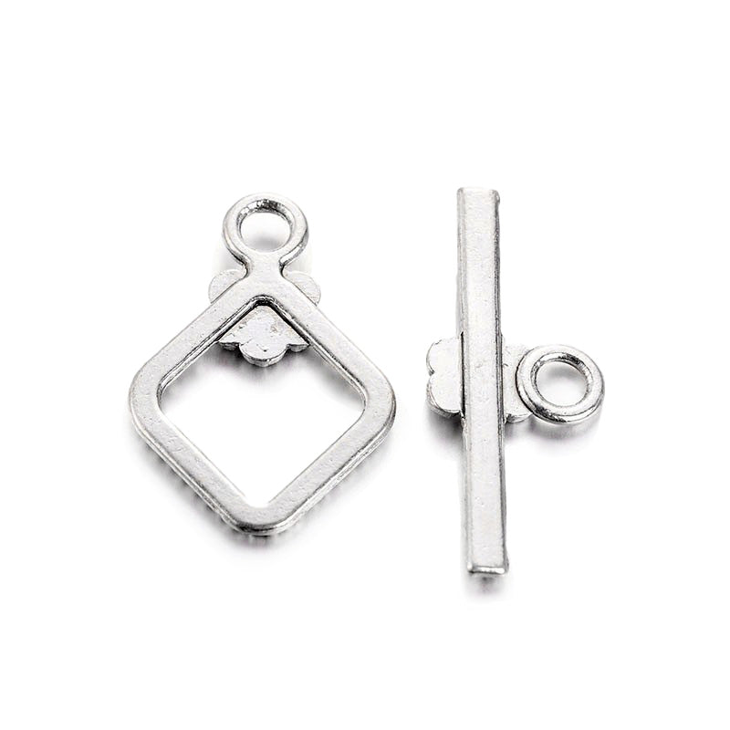 Rhombus with Flower Design Toggle Clasps for DIY Jewelry Making.  Size: 21mm Length, 15mm Width; Bar: 24x10mm, Hole: 2mm, 5 set/package.  Material: Antique Silver Color Alloy Toggle Clasps, Cadmium and Lead Free.   Usage: These Clasp are used to finish off necklaces or bracelets.