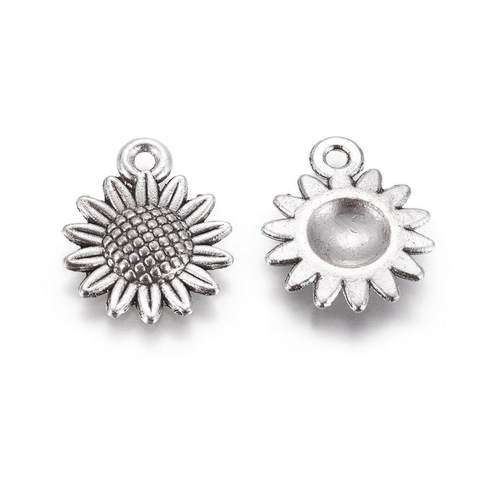 Silver Sunflower Charm Beads, Antique Silver Colored Vintage Flower Charms for DIY Jewelry Making. Sunflower Charms for Bracelet and Necklace Making.  Size: 18mm Length, 15mm Width, 2.5mm Thick, Hole: 1.8mm, Quantity: 10 pcs/package.  Material: Alloy (Lead and Nickel Free) Charms. Antique Silver Color. Shinny Finish.