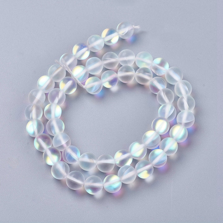 Frosted Synthetic Moonstone Beads, Round, Clear Color. Matte Holographic Beads for DIY Jewelry Making.  Size: 8mm in Diameter, Hole: 1mm, approx. 45-47pcs/strand, 14.5" Inches Long.  Material: Synthetic Frosted Moonstone Beads, Transparent Frosted Clear Color. Holographic Purple Beads. Frosted Matte Finish.