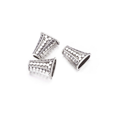 Tibetan Bead Cones, Antique Silver Colored Cones for DIY Jewelry Making. Add the perfect Finishing Touch to Your Jewelry Designs with these Stylish Caps. Great for Tassel Pendants.  Size: 17mm Wide, 18mm Length, 9mm Thick, Hole: 4mm, Quantity: 4pcs/bag.  Material: Alloy (Lead and Nickel Free) Bead Cone. Antique Silver Color. Shinny Finish.