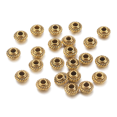 Tibetan Spacer Beads, Flower, Antique Gold Color Metal Findings. Silver Spacers for DIY Jewelry Making Projects. High Quality, Classy, Non-Tarnish Spacers for Beading Projects.  Size: 5mm Wide, 3mm Thick, Hole: 1.5 mm, approx. 25pcs/bag.   Material:  Antique Gold Tibetan Style, Shinny Finish. 100% Lead and Nickel Free Spacers.
