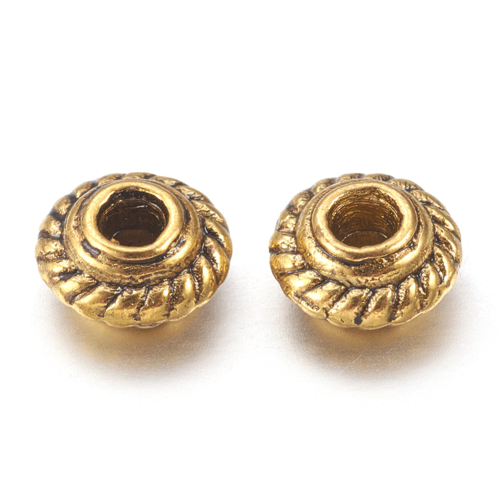 Tibetan Spacer Beads, Flower, Antique Gold Color Metal Findings. Silver Spacers for DIY Jewelry Making Projects. High Quality, Classy, Non-Tarnish Spacers for Beading Projects.  Size: 5mm Wide, 3mm Thick, Hole: 1.5 mm, approx. 25pcs/bag.   Material:  Antique Gold Tibetan Style, Shinny Finish. 100% Lead and Nickel Free Spacers.