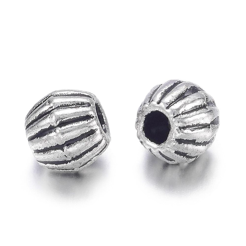 Tibetan Bicone Spacer Beads, Antique Silver Color. Silver Spacers for DIY Jewelry Making Projects. High Quality, Classy, Non-Tarnish Spacers for Beading Projects.  Size: 4.5mm Wide, 4mm Length, Hole: 1mm, approx. 25pcs/bag.   Material:  Antique Silver Tibetan Style, Shinny Finish. Cadmium, Lead and Nickel Free Spacers.