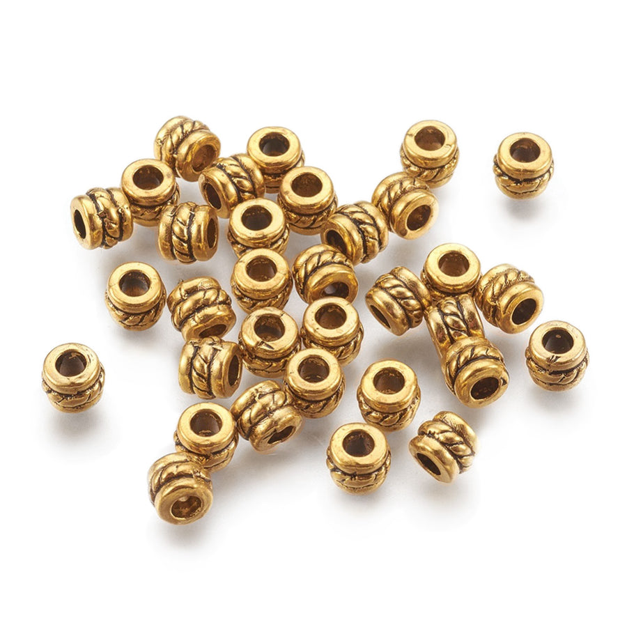 Tibetan Column Shaped Spacer Beads, Antique Gold Color. Gold Spacers for DIY Jewelry Making Projects. High Quality, Classy, Non-Tarnish Spacers for Beading Projects.  Size: 5mm Length, 4mm Width, Hole: 2.2mm, approx. 25pcs/bag.   Material: Tibetan Style, Antique Gold Color, Shinny Finish. Cadmium, Lead and Nickel Free Spacers. Barrel Shaped Spacers.