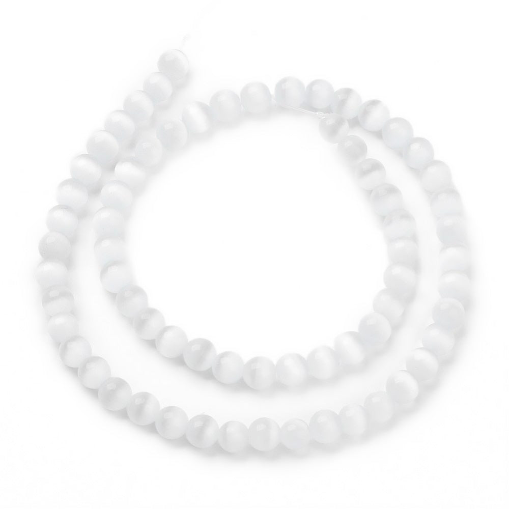 Cat Eye Glass Beads, Round, White Color.  Size: 6mm Diameter, Hole: 1mm; approx. 64pcs/strand, 14" Inches Long  Material: Glass Beads; Cats Eye Glass Beads. White Color. Polished, Shinny Finish.
