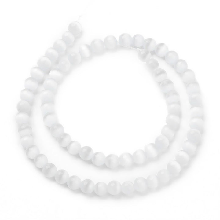 Cat Eye Glass Beads, Round, White Color.  Size: 6mm Diameter, Hole: 1mm; approx. 64pcs/strand, 14" Inches Long  Material: Glass Beads; Cats Eye Glass Beads. White Color. Polished, Shinny Finish.