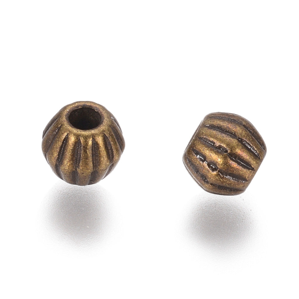 Tibetan Bicone Spacer Beads, Antique Bronze Color. Bronze Spacers for DIY Jewelry Making Projects. High Quality, Classy, Non-Tarnish Spacers for Beading Projects.  Size: 4.5mm Wide, 4mm Length, Hole: 1mm, approx. 25pcs/bag.   Material:  Antique Bronze Tibetan Style, Shinny Finish. Cadmium, Lead and Nickel Free Spacers.